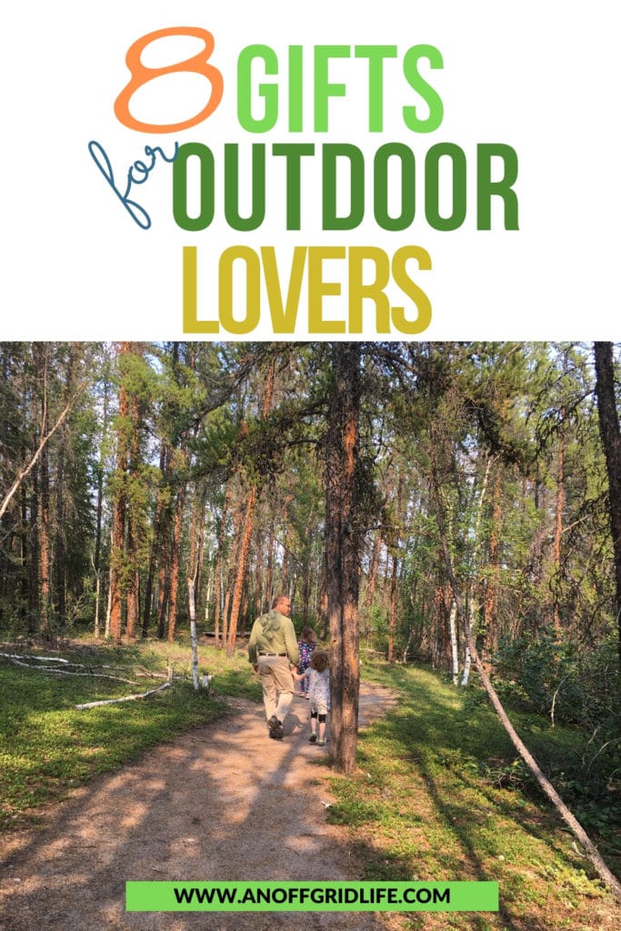 Man and children walking on a trail in the woods