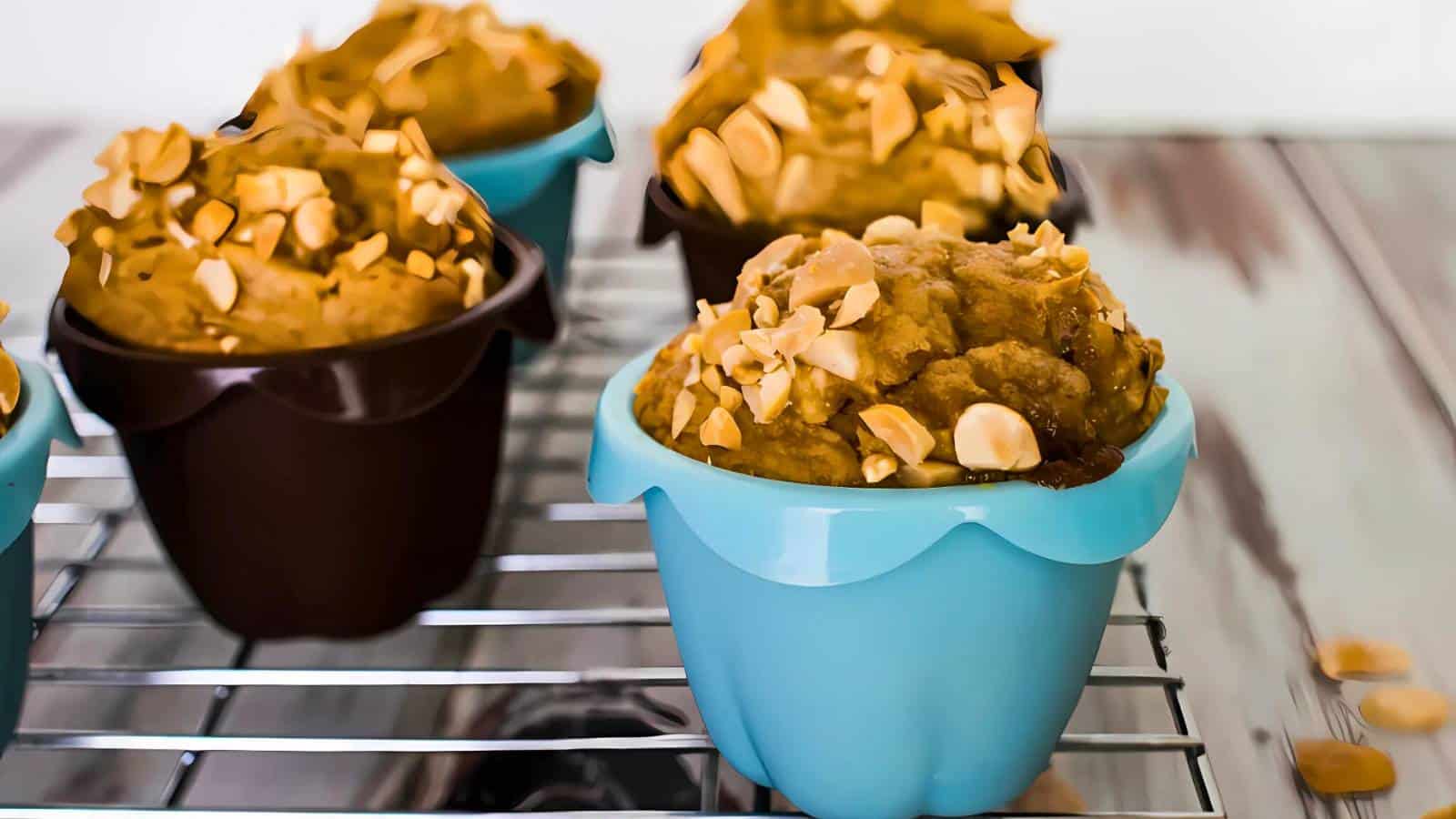 Loaf of homemade bread topped with chopped peanuts placed on a cooling rack.