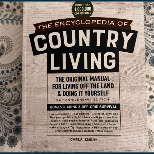 Cover of "The Encyclopedia of Country Living" by Carla Emery, featuring text about homesteading, off-grid survival, and living off the land on a rustic background.