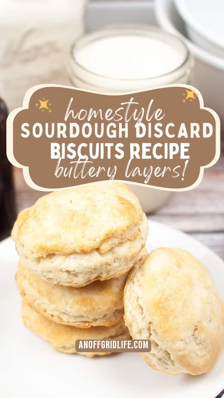 A stack of golden brown biscuits sits in front of a glass jar of milk, with text overlay reading "Homestyle Sourdough Discard Biscuits Recipe Buttery Layers!.