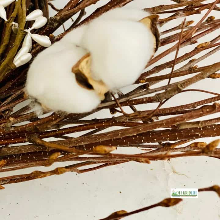 Cotton balls attached to farmhouse wreath with twist ties.
