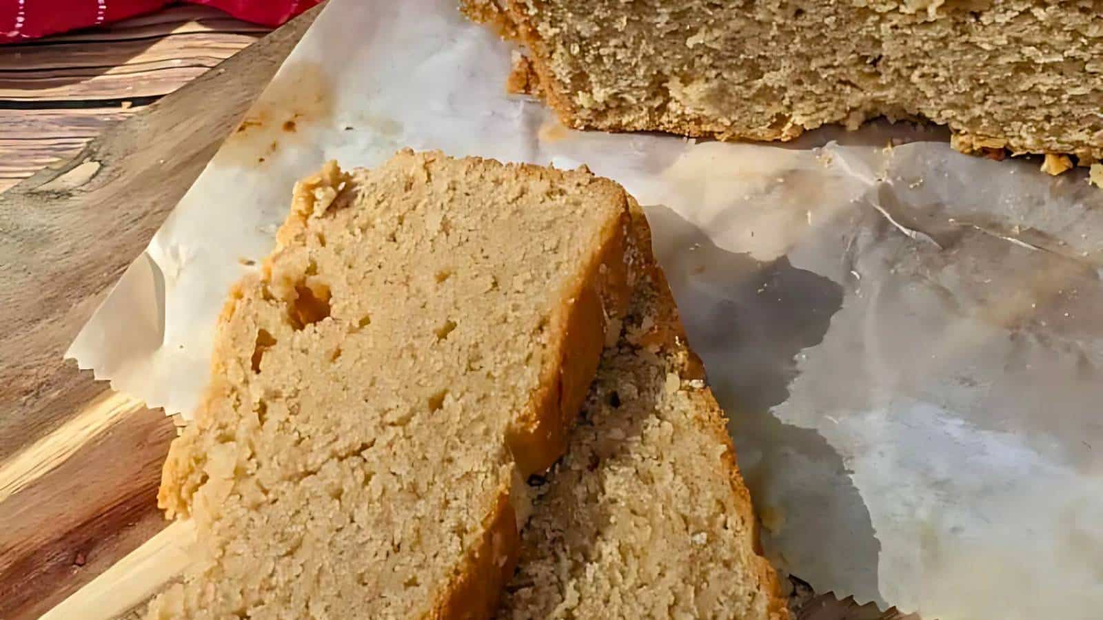 Slices of bread on parchment paper, with a wooden cutting board partially visible underneath.