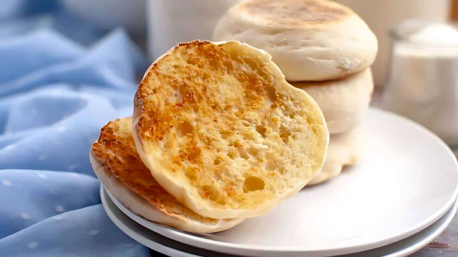 Glass jar filled with overflowing bread dough on a wooden surface, next to a metal whisk and a slightly opened lid.