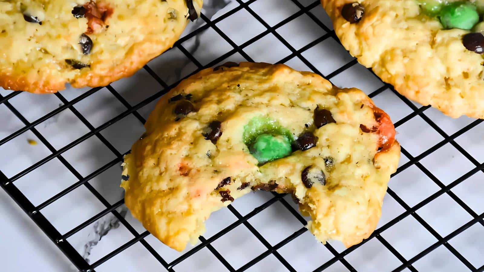 A plate of eight cracked, round cookies on a blue rimmed plate.