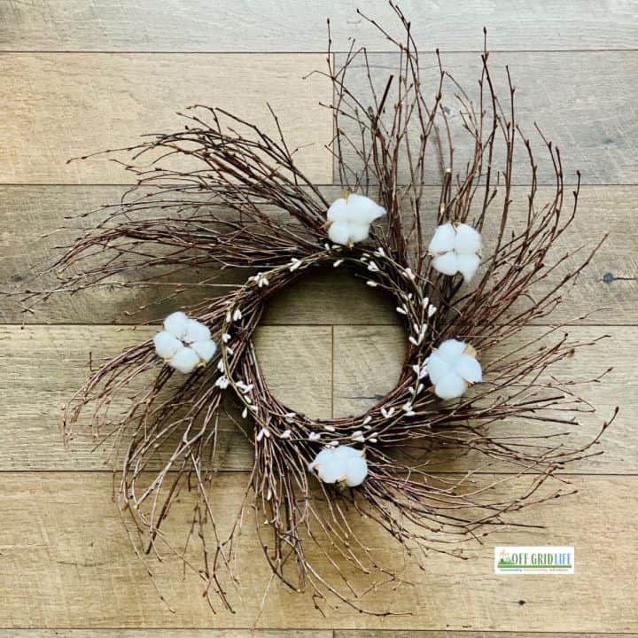 Simple farmhouse wreath on wooden background.