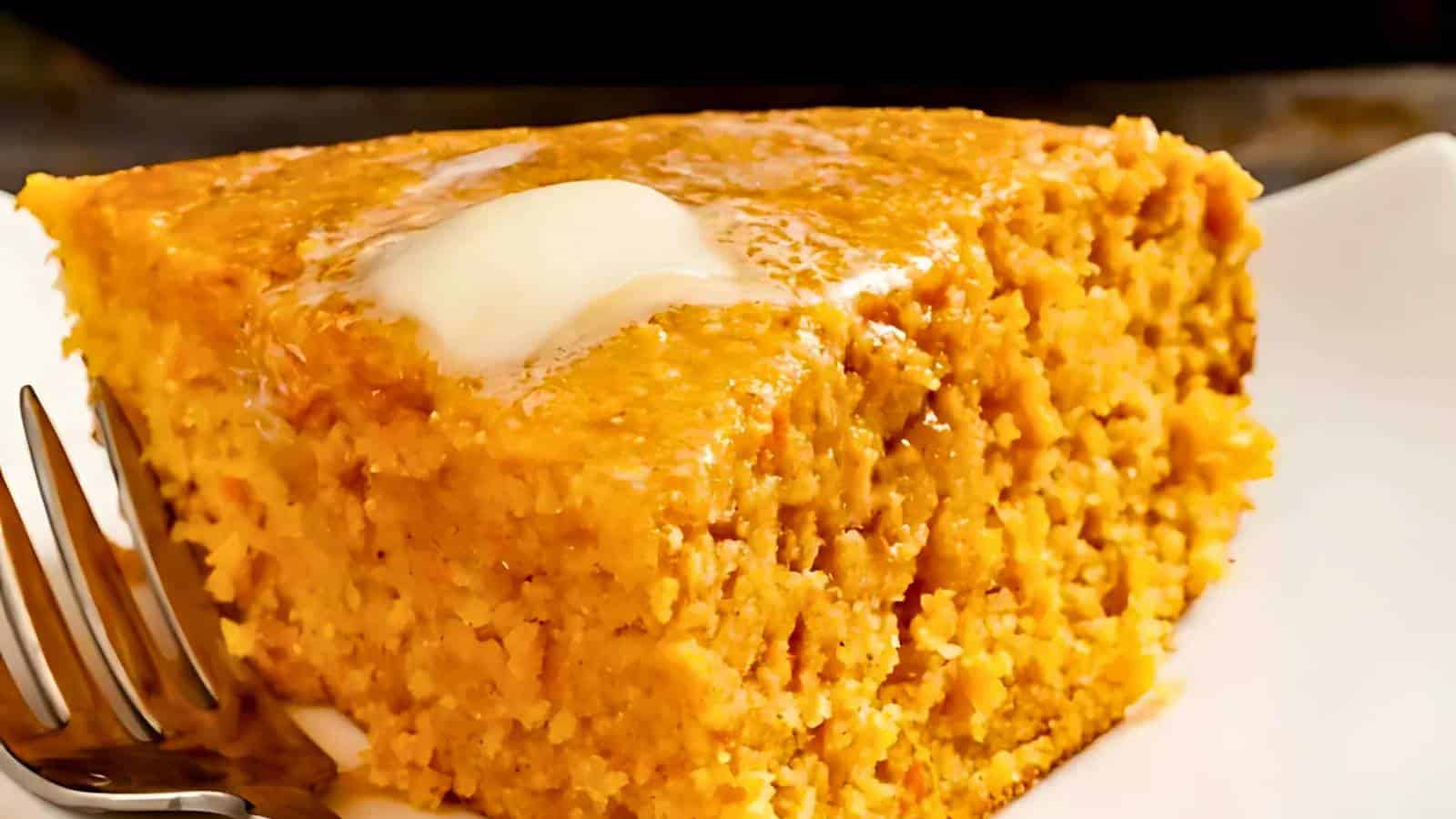 A frittata cooking in a cast iron skillet, with visible cherry tomatoes and herbs, set on a grill.