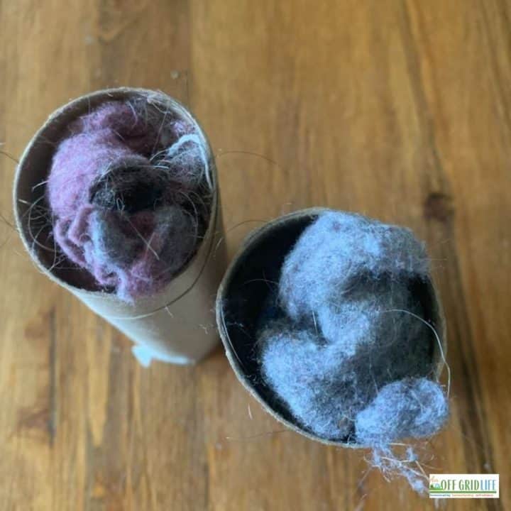 two toilet paper cardboard rolls stuffed with dryer lint