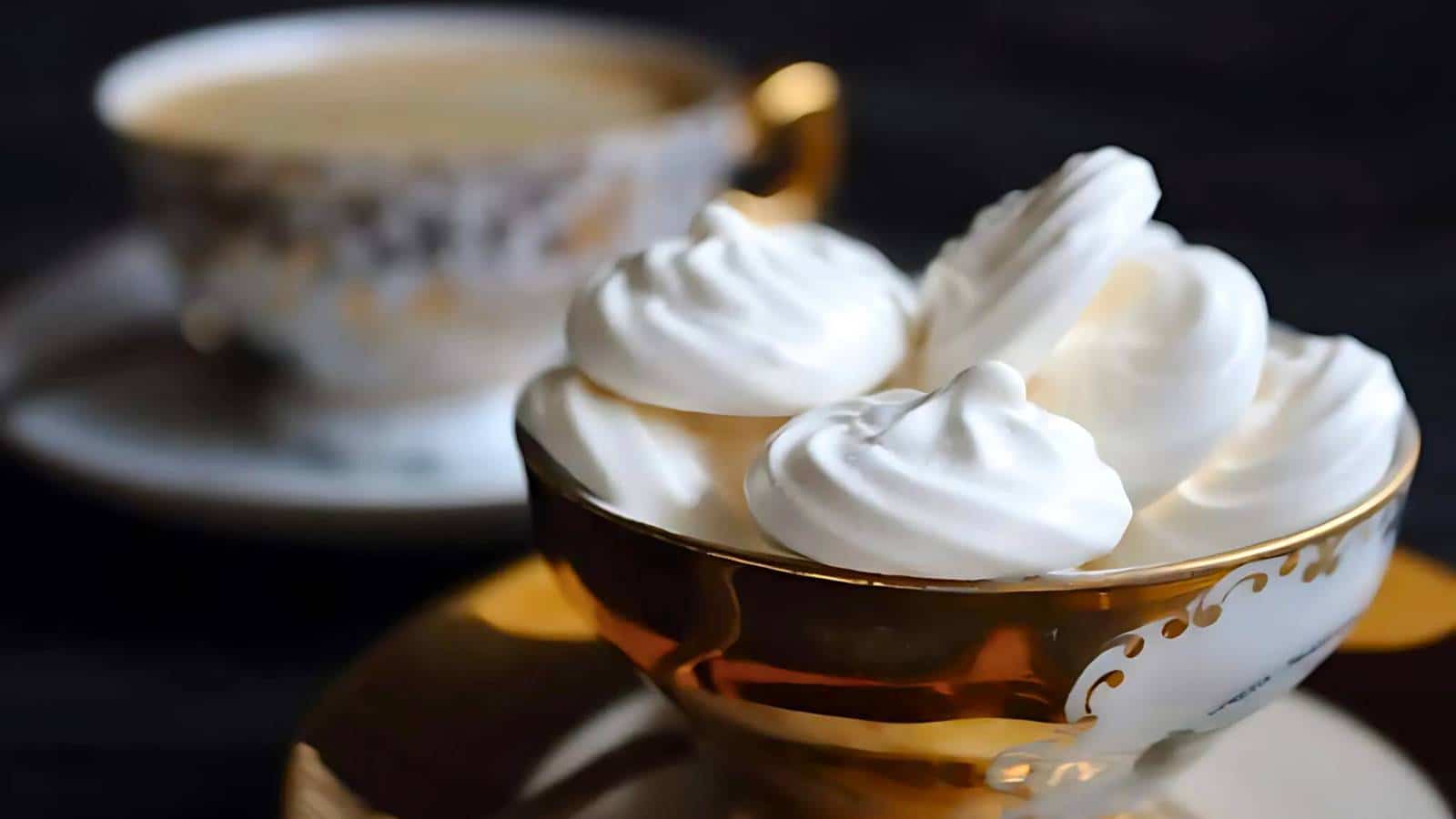 Glass container with homemade nougat bars topped with dark chocolate. Bars contain nuts and dried fruit pieces.