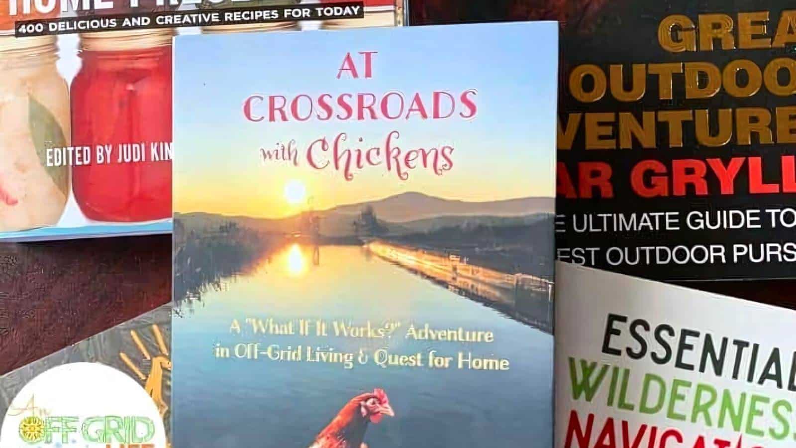 Book titled "At Crossroads with Chickens" on a wooden surface, surrounded by books on outdoor adventures and survival skills.