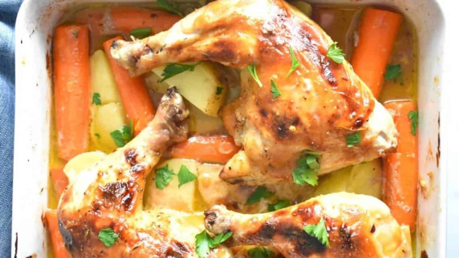 Roasted chicken legs with carrots and potatoes in a baking dish, garnished with fresh herbs.