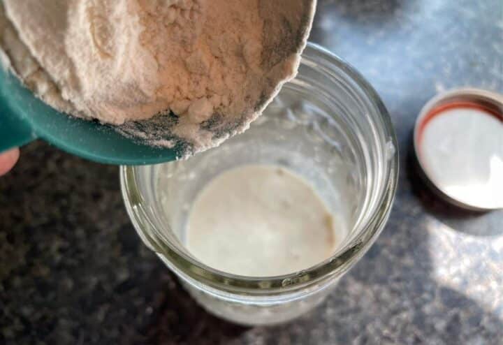 Adding flour and water to dehdyrated sourdough starter.
