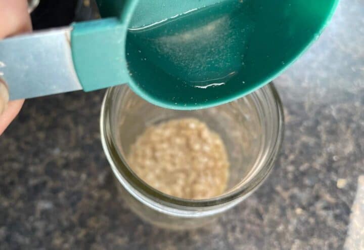 Adding water to rehydrate sourdough starter.