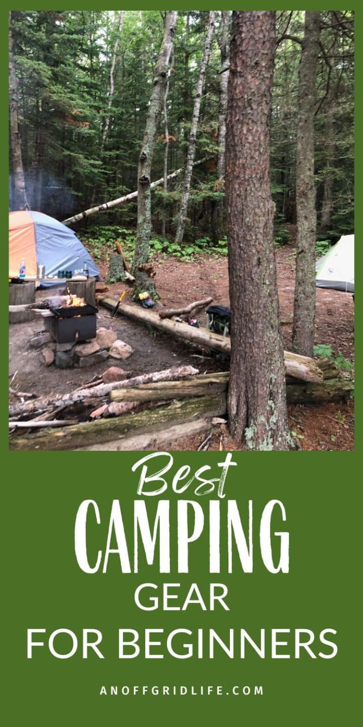 A campsite in a forest with two tents, a campfire, and various camping gear. Text reads: "Best Camping Gear for Beginners. anoffgridlife.com".