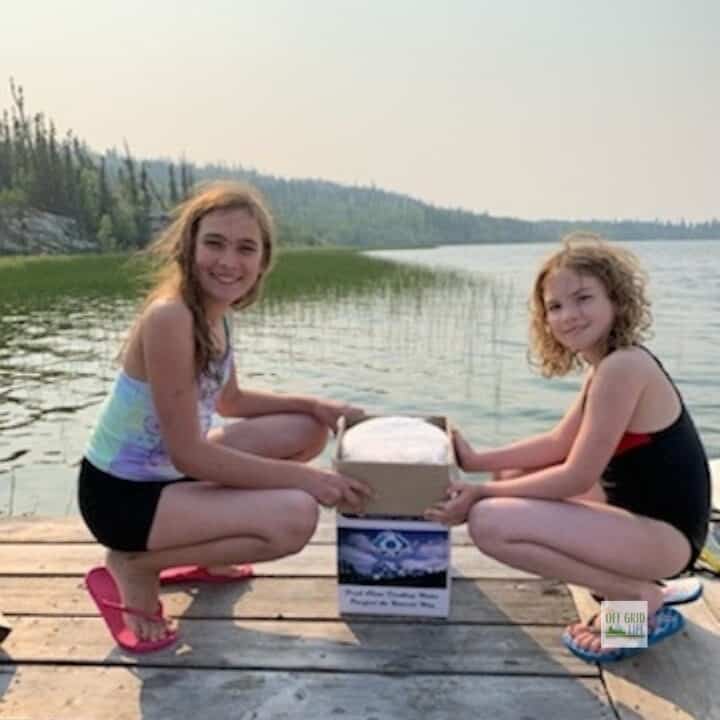 Our two youngest kids with our Berkey water filter down on our dock.