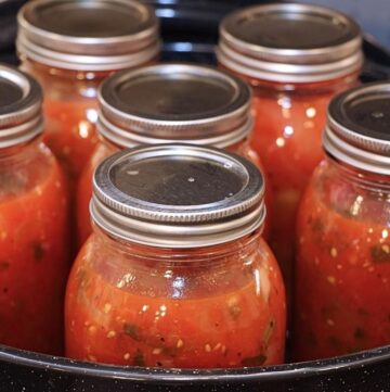 Water bath canning tomato sauce.