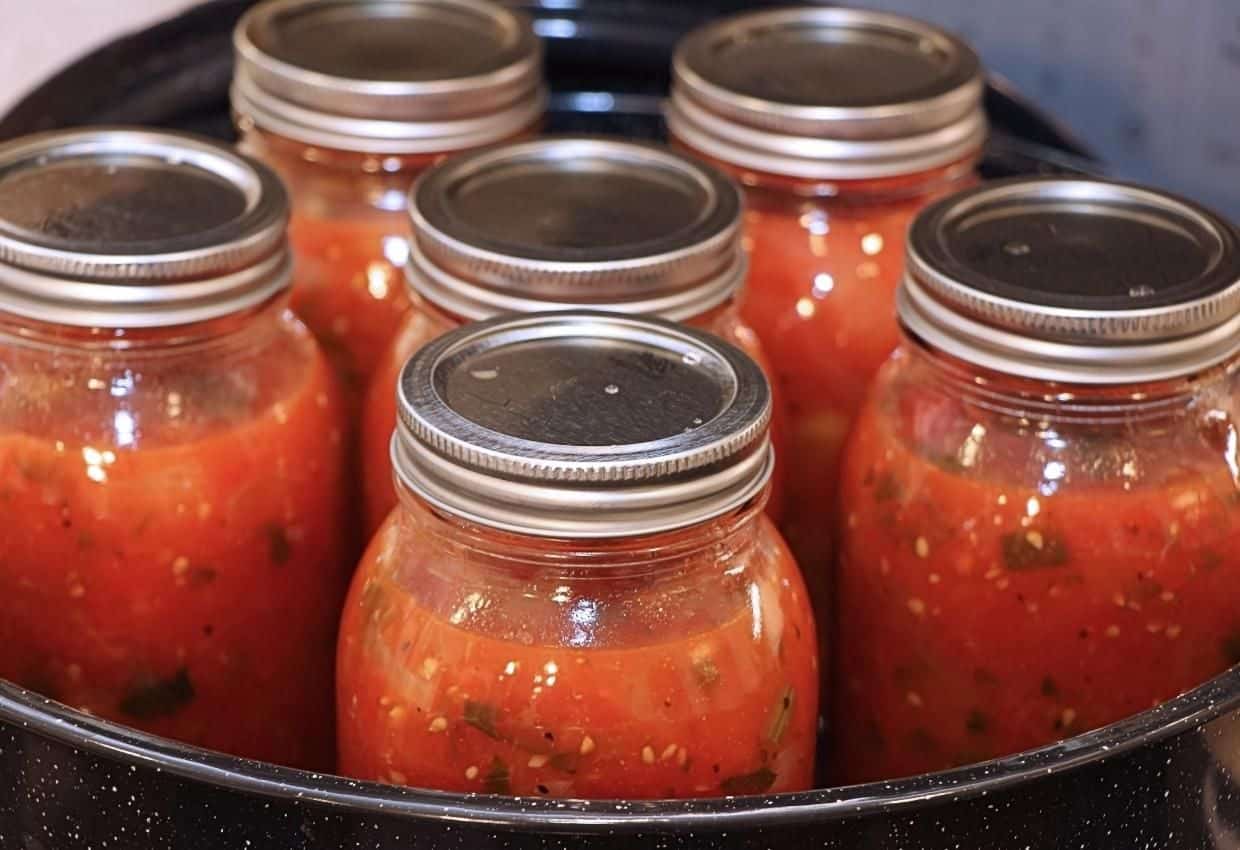 Water bath canning tomato sauce.