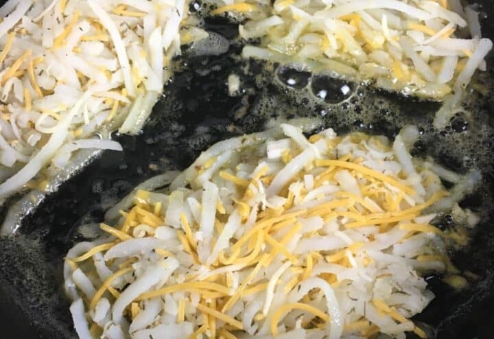 Cheesy hash browns in skillet.