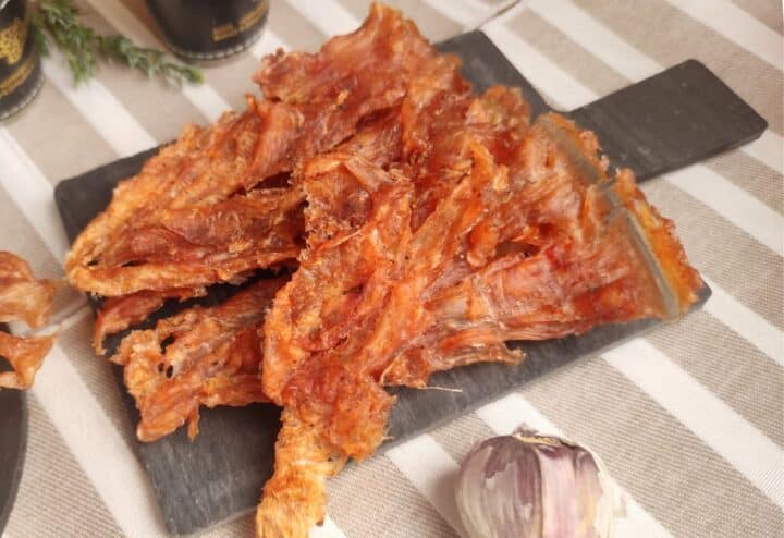 Chicken jerky on plate.