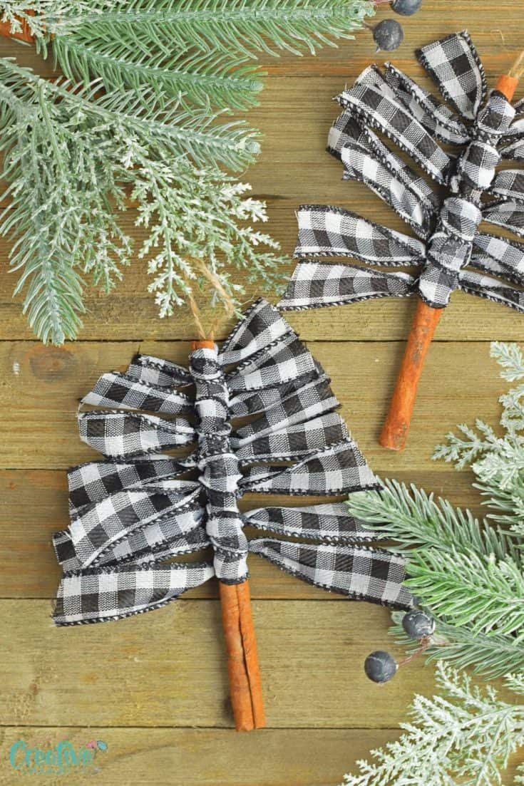 Two plaid Christmas tree ornaments on a wooden table, showcasing pioneer crafts for kids during the holiday season.
