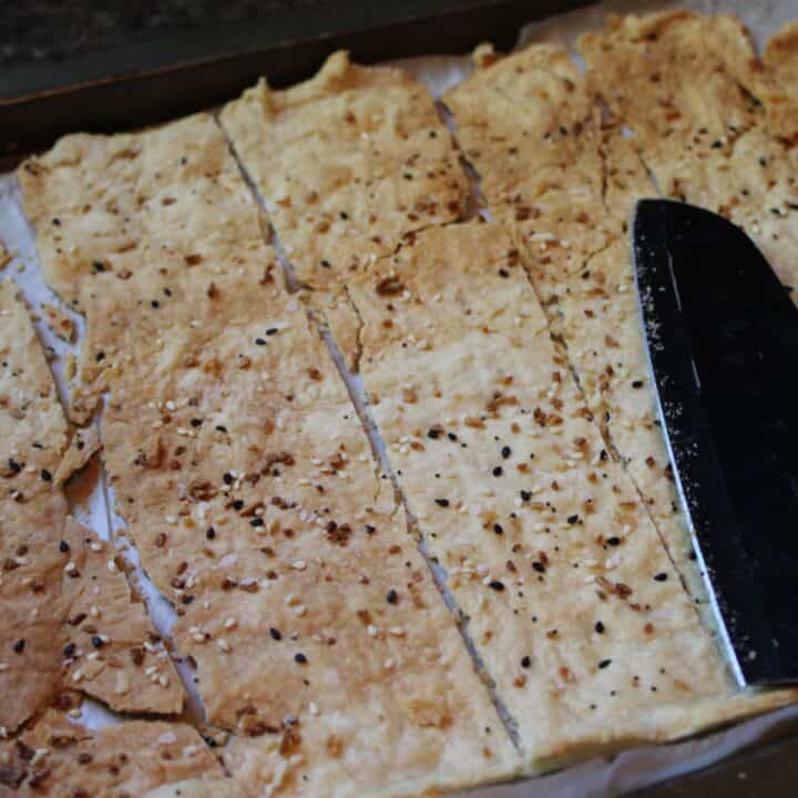 Cutting sourdough discard crackers.