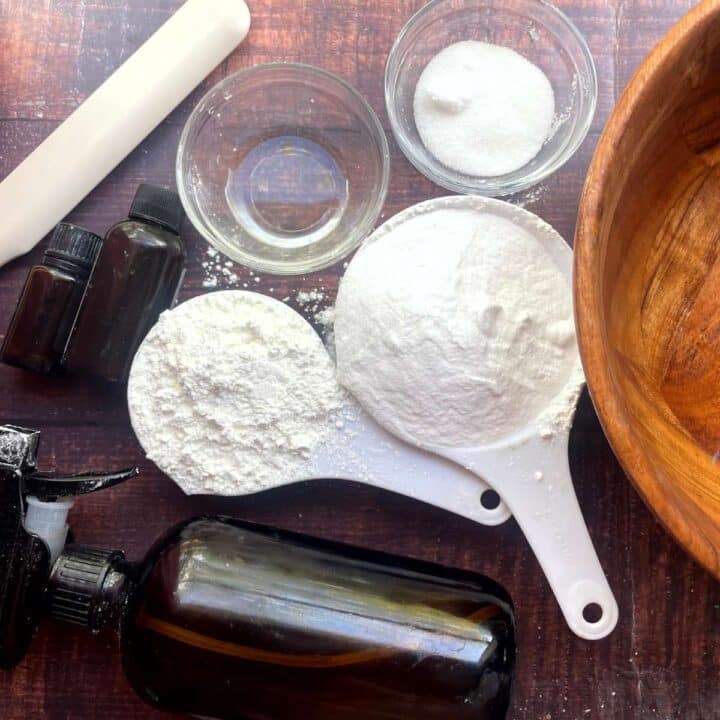 A bowl of flour, sugar, and other ingredients on a wooden table.