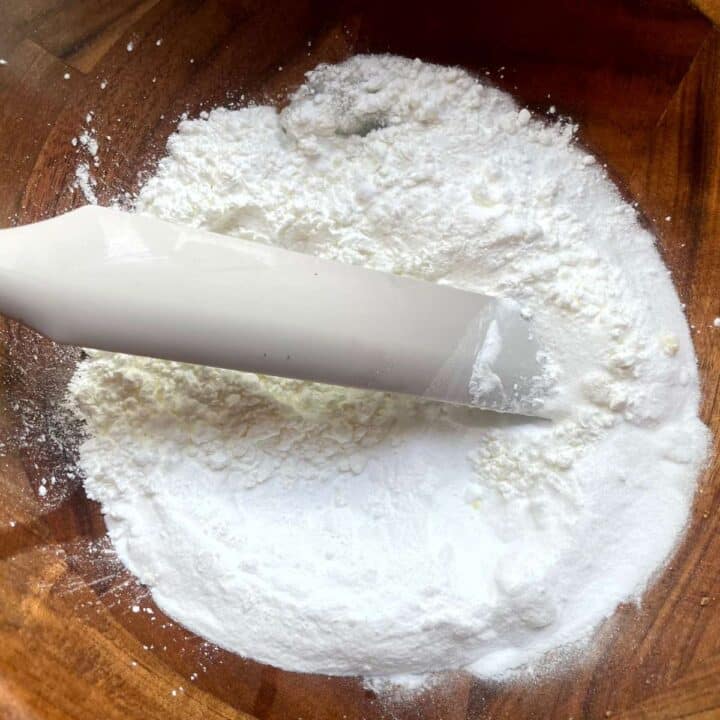 DIY aromatherapy shower steamer mixture with eucalyptus and peppermint in a wooden bowl.