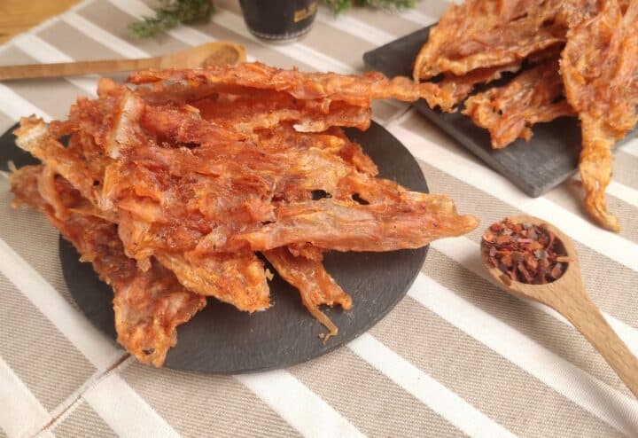 Dehydrated chicken jerky on plate.