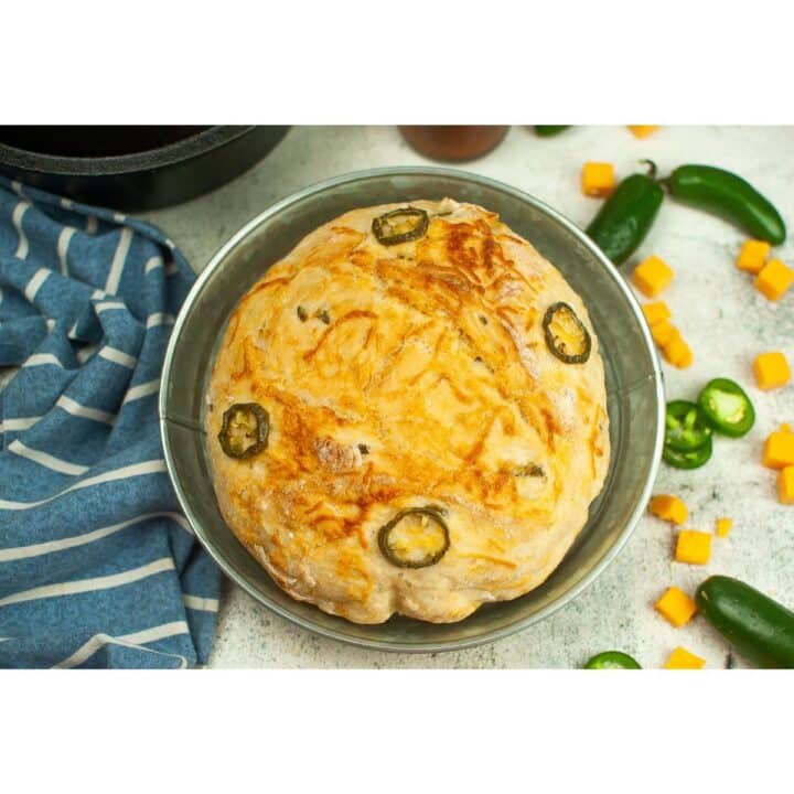Jalapeno cheddar bread in a pan with jalapeos.
