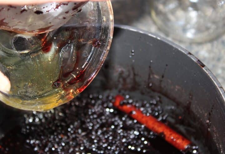 A person pouring a liquid into a pan.
