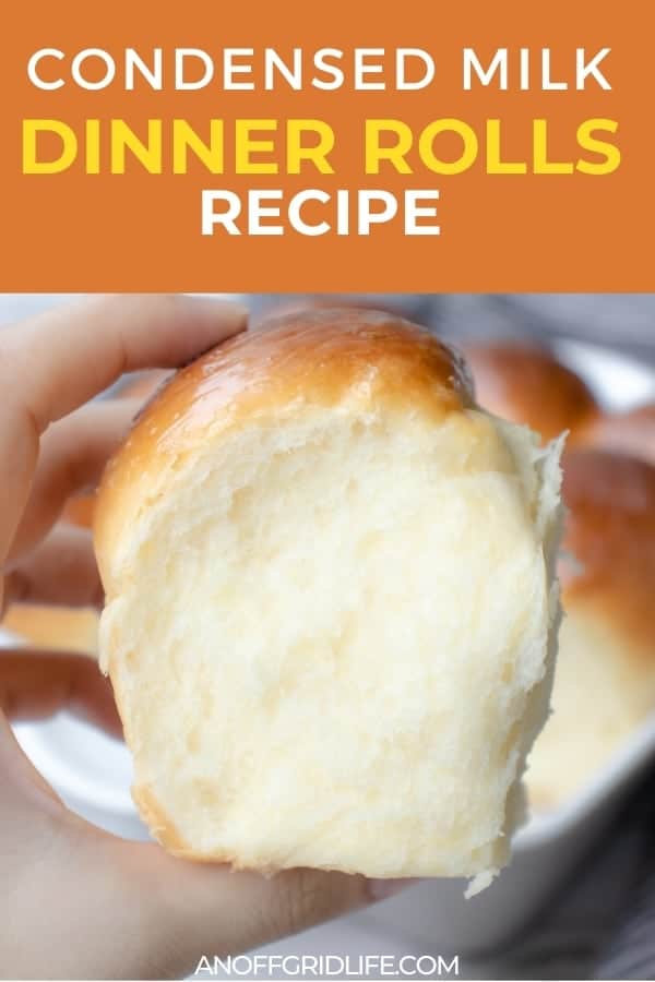 Condensed Milk Dinner Rolls Recipe text overlay on image of hand holding fresh baked roll