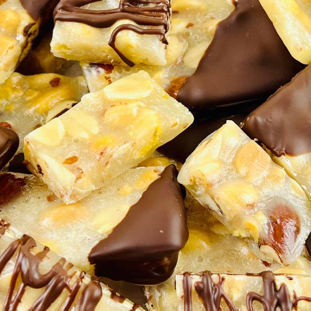 A close up of a piece of chocolate fudge with nuts.
