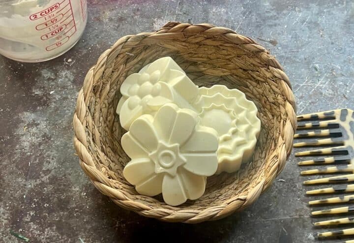 A wicker basket filled with soap and a comb.