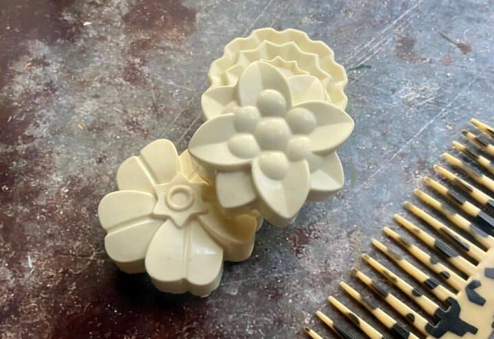 A set of flower shaped soap molds on a table.