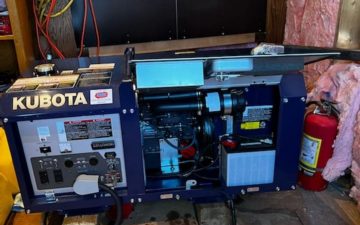 a picture of a blue kubota generator in a generator shed