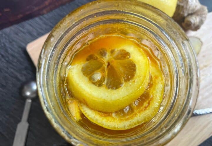 A jar with lemon slices and ginger in it.