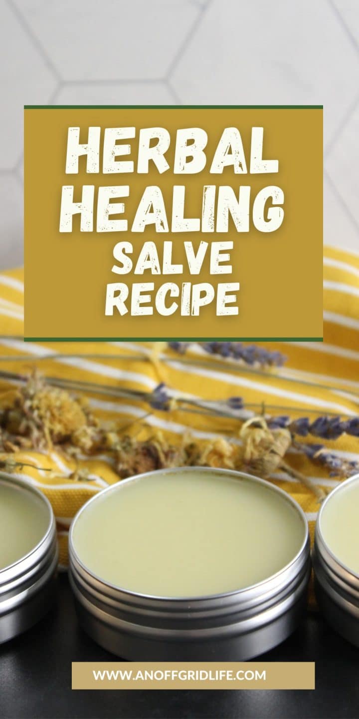 Three tins of herbal salve sit on a surface with dried herbs. Text overlay reads "Herbal Healing Salve Recipe." Website link at the bottom.