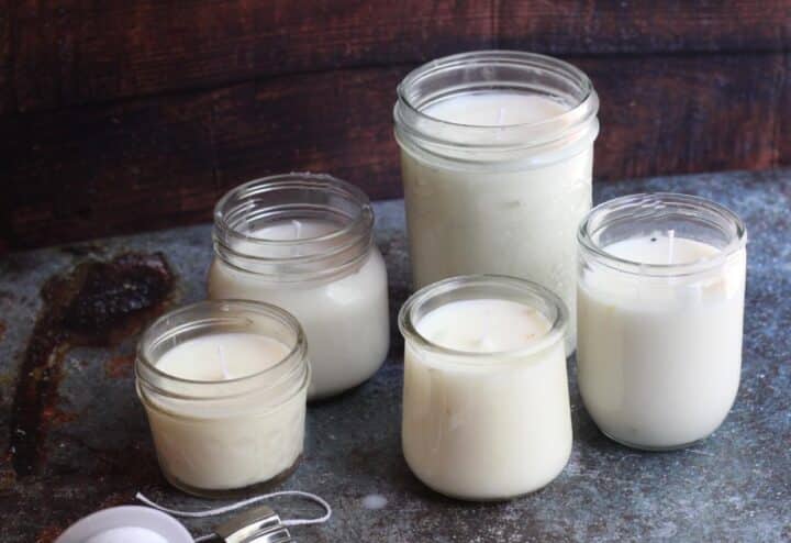 Four mason jars filled with white candles.