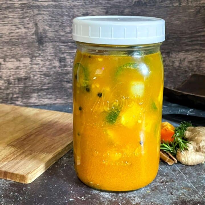 Homemade fire cider recipe in a mason jar.