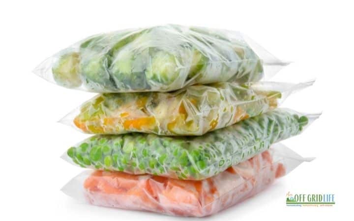 four stacks of ziploc bags filled with frozen vegetables