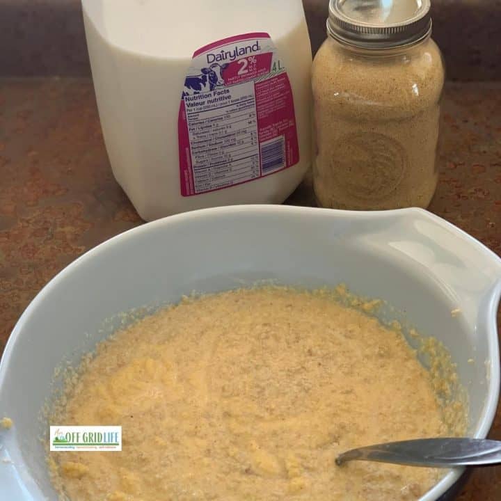 Cornmeal in a mason jar, jug of milk, and cornbread mix in a bowl.