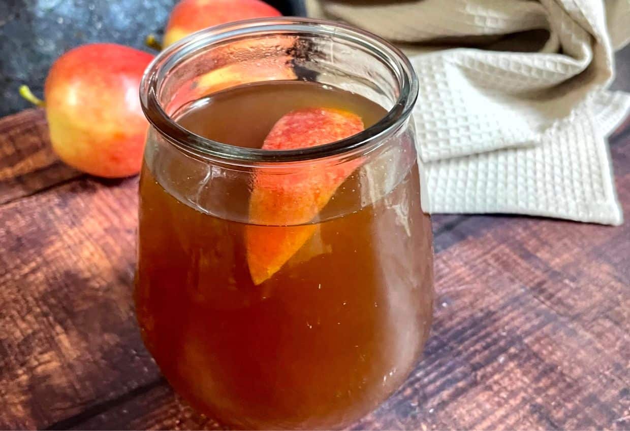A mason jar filled with apple cider.