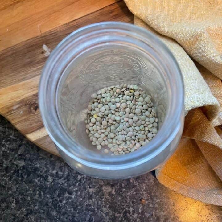 Green lentils in a glass jar.