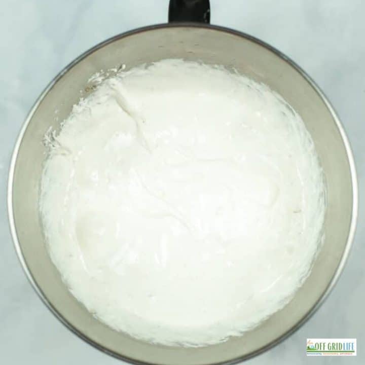 a marshmallow mixture in a stainless steel mixing bowl