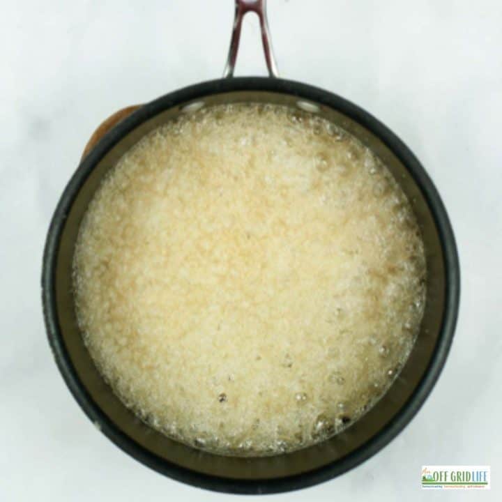 a pot with sugar and water boiling on high heat