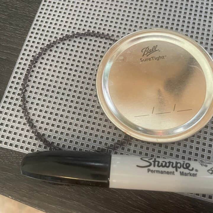 Marker, mason jar ring lid, and plastic canvas for making sprouting lids.