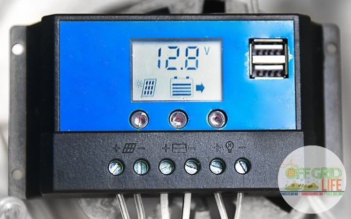 Charge controller on a wall showing voltage