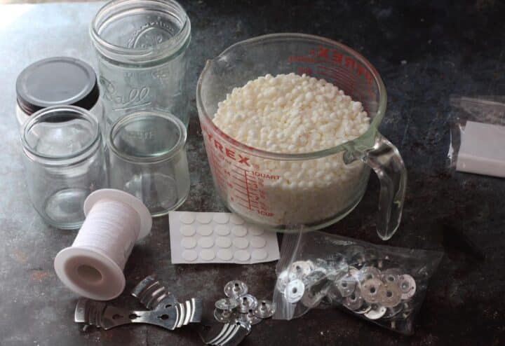 Mason jars, jars, and other supplies on a table.
