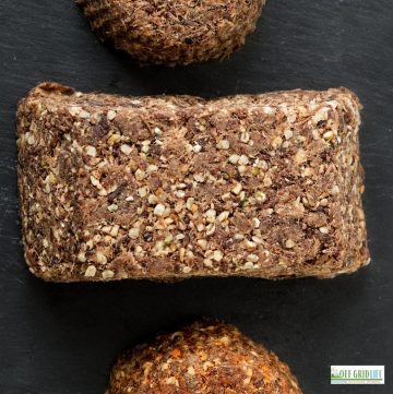 A picture of 3 pieces of pemmican made with game meat and a black background.