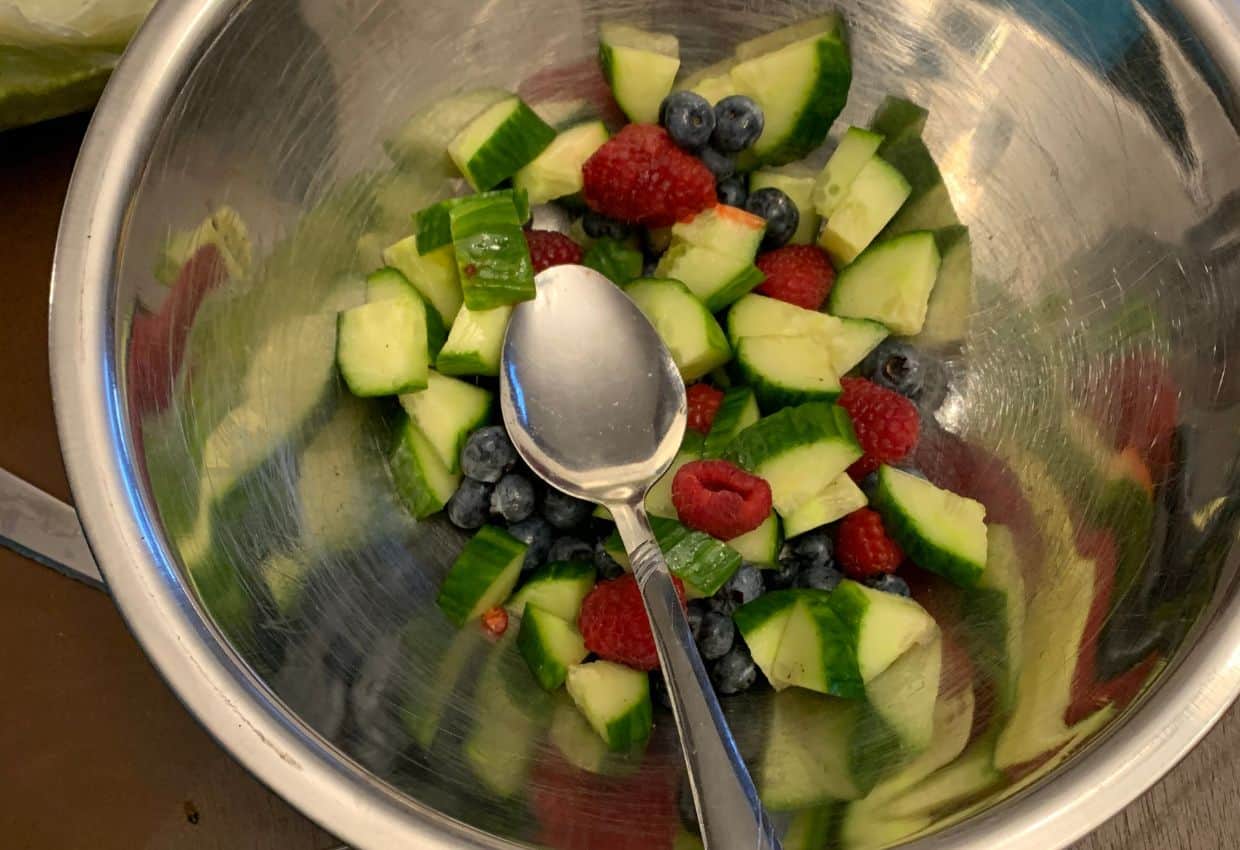Making cucumber berry fruit salsa.