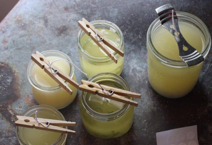 Jars of lemon juice with clothespins on a table.